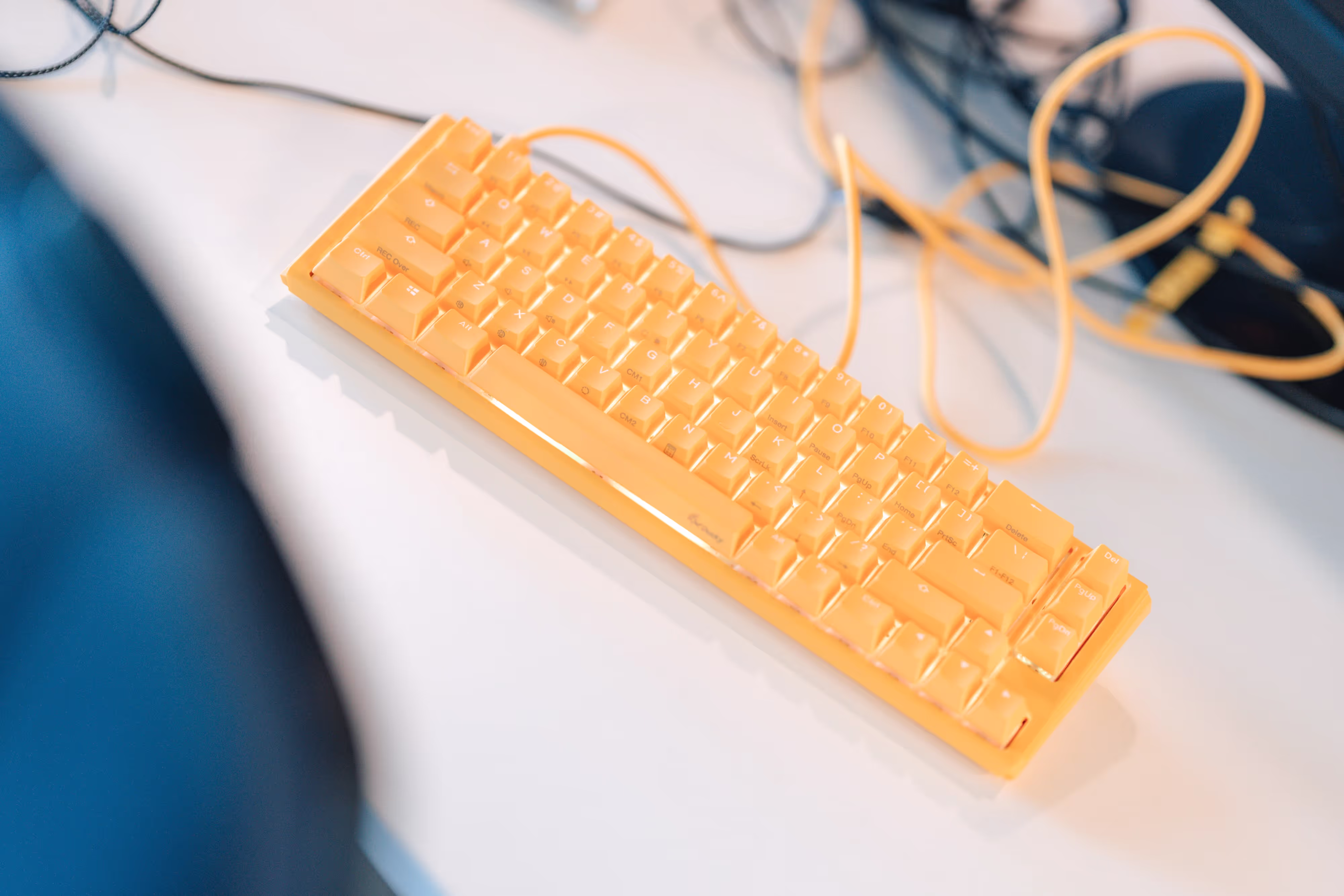 A yellow keyboard sitting on top of a white desk.