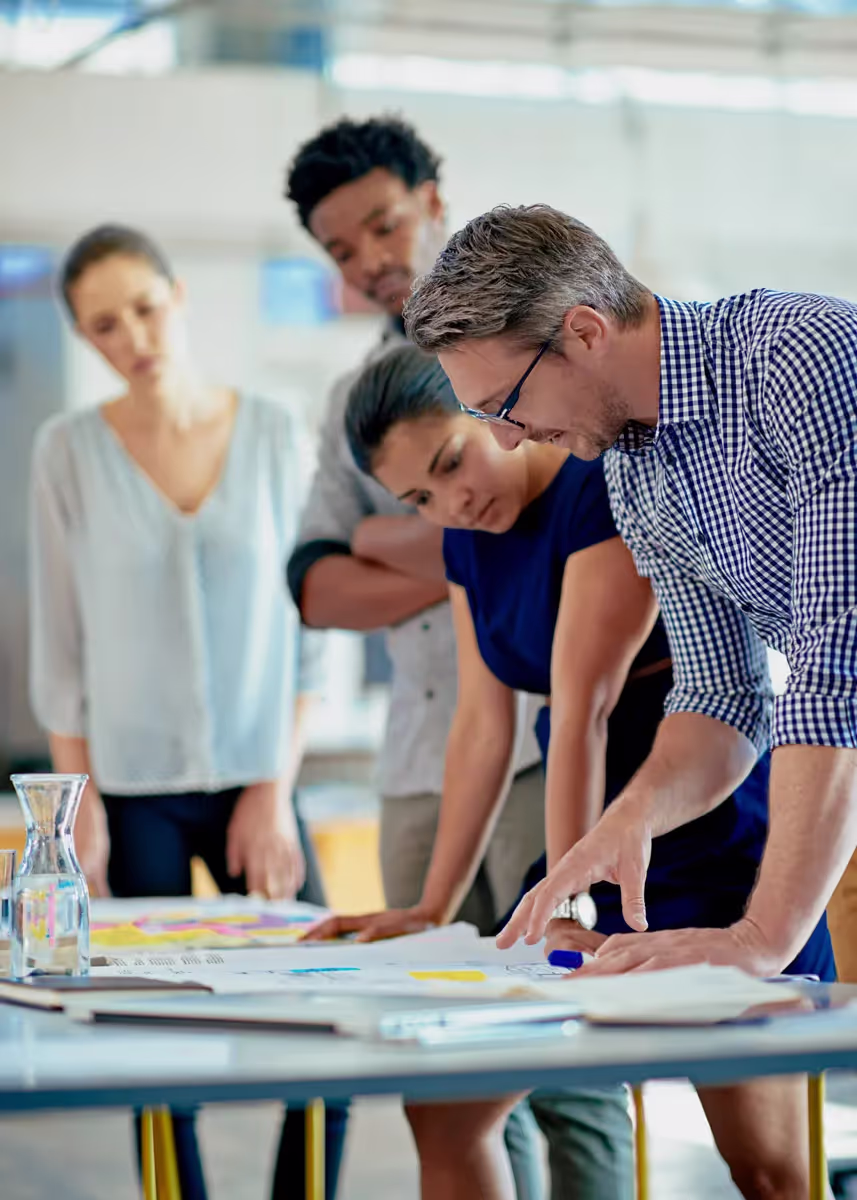 A group of people standing around a table.
